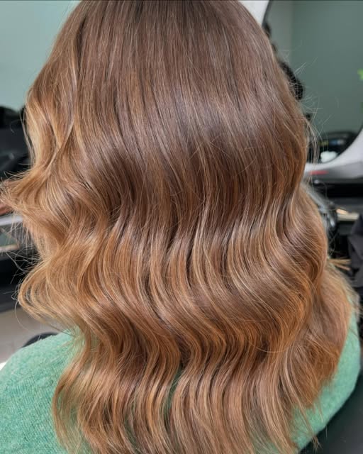 A warm copper balayage finished in waves