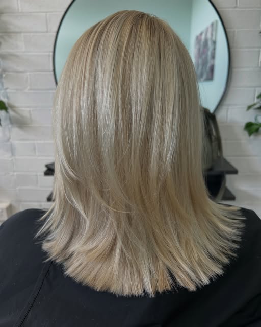 A blunt blonde lob cut and styled smooth